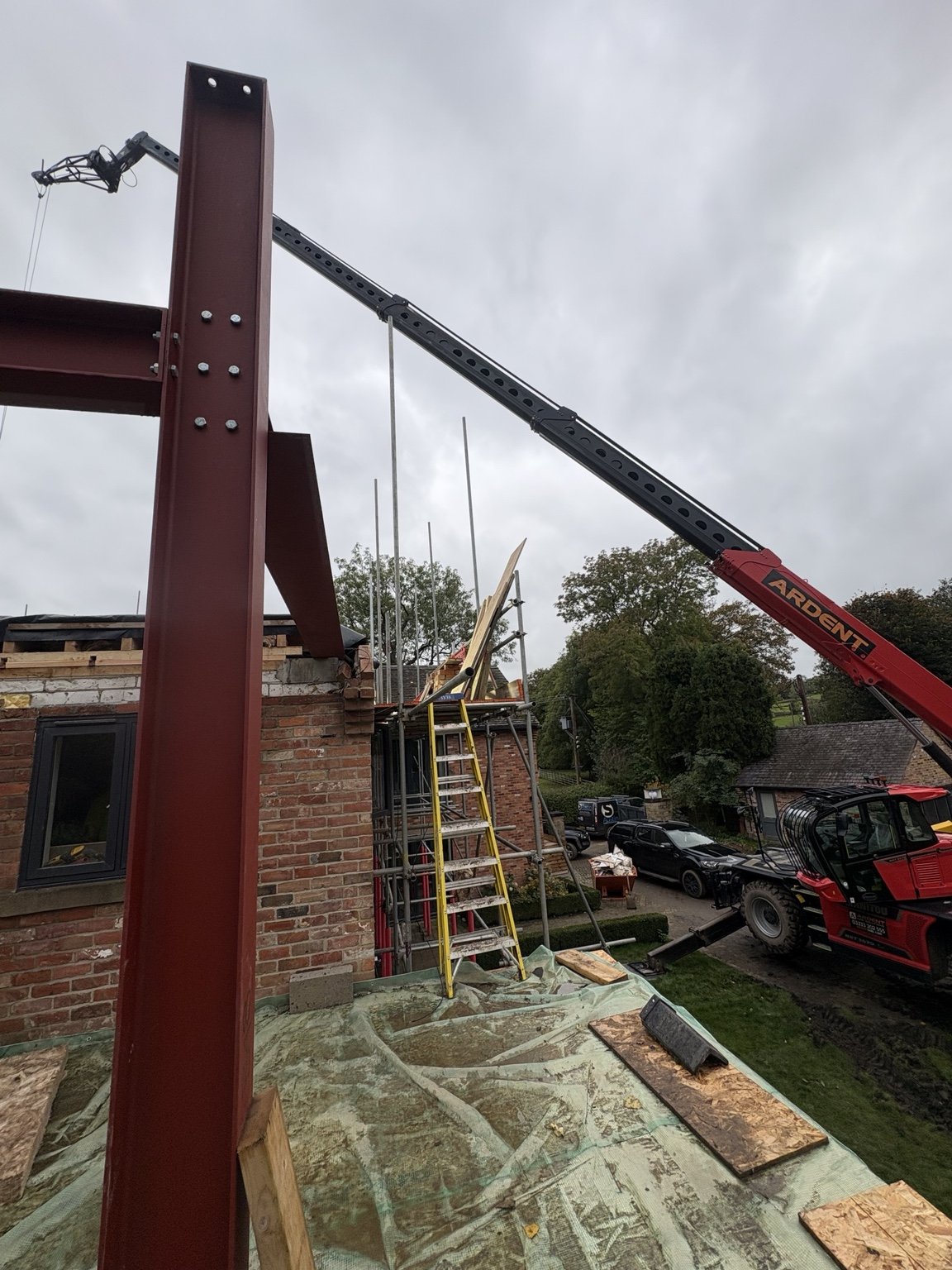 Close-up of bolted structural steel column and lifting operation at South View